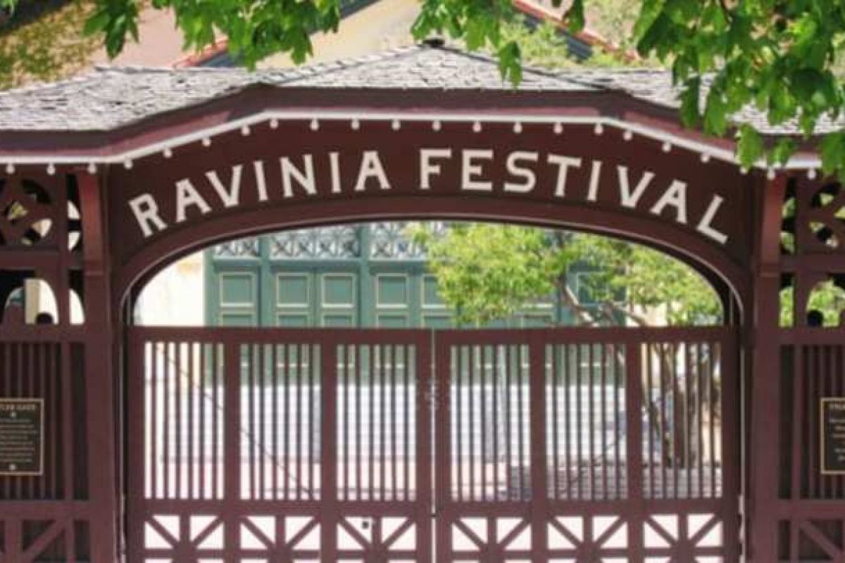 Optima Verdana luxury apartment with Entrance gate to Ravinia, the Summer Music Festival near Wilmette, with a wooden arch and lush green foliage overhead.