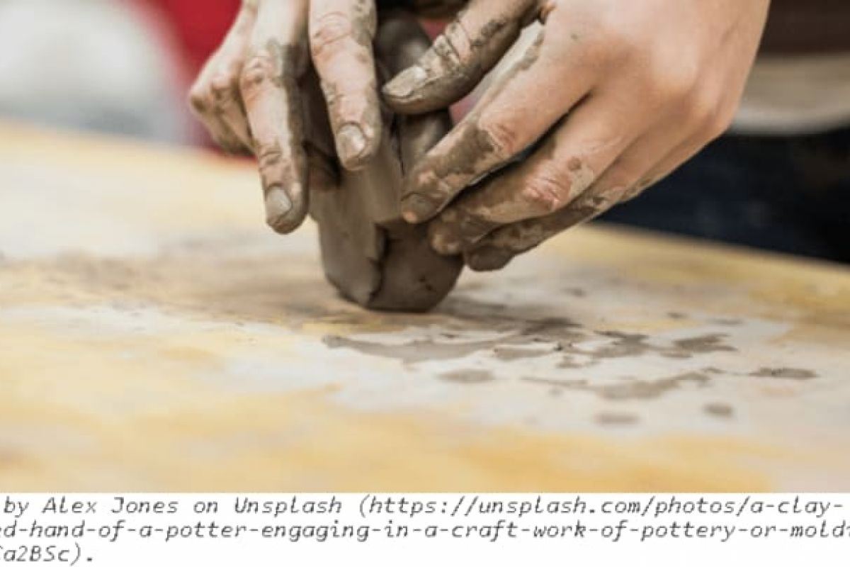 Optima Verdana luxury apartment with Close-up of muddy hands shaping wet clay at the Wilmette Park District Center for the Arts, creating pottery.