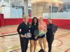 Optima Verdana luxury apartment with Four women smiling and holding pickleball paddles on an indoor court, part of our active pre-move checklist.
