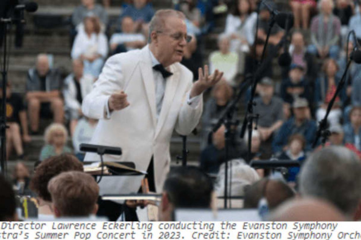 Optima Verdana luxury apartment with A conductor in a white jacket leads an orchestra outdoors, filling the evening with music as a seated audience listens under the stars.