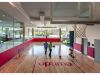 Optima Verdana luxury apartment with Two people walk on an indoor basketball court with "optima" written on the floor, enjoying daily life in the Optima Community.