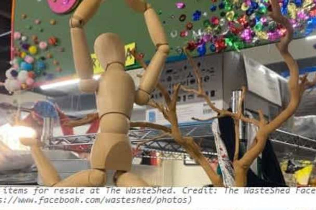 Optima Verdana luxury apartment with A wooden mannequin holds its arms up beside a bare branch at The WasteShed, Chicago’s hub for creative reuse and craft supplies.