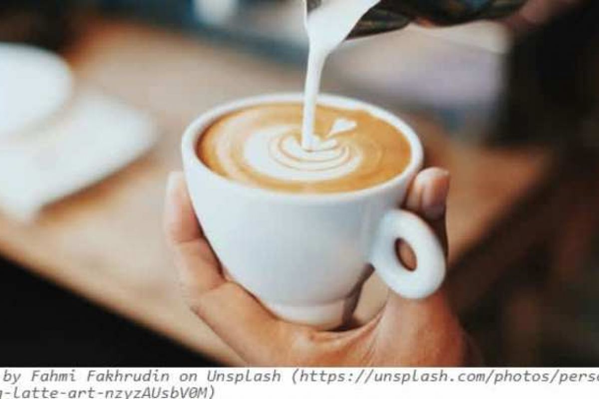 Optima Verdana luxury apartment with A hand holds a cup while milk is poured to create latte art, capturing the warmth of café culture in a Wilmette café.