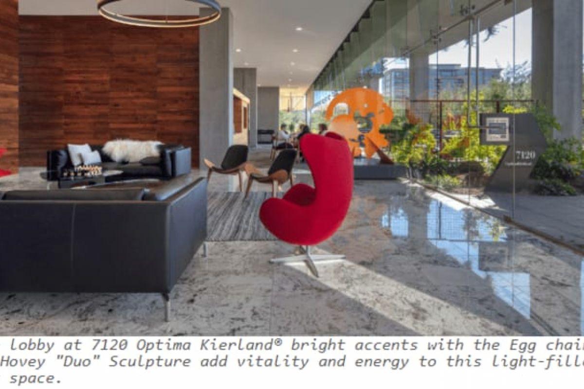 Optima Verdana luxury apartment with Modern lobby at Optima Verdana with a red Egg chair, black sofas, wood walls, and large window framing color stories in architecture outside.