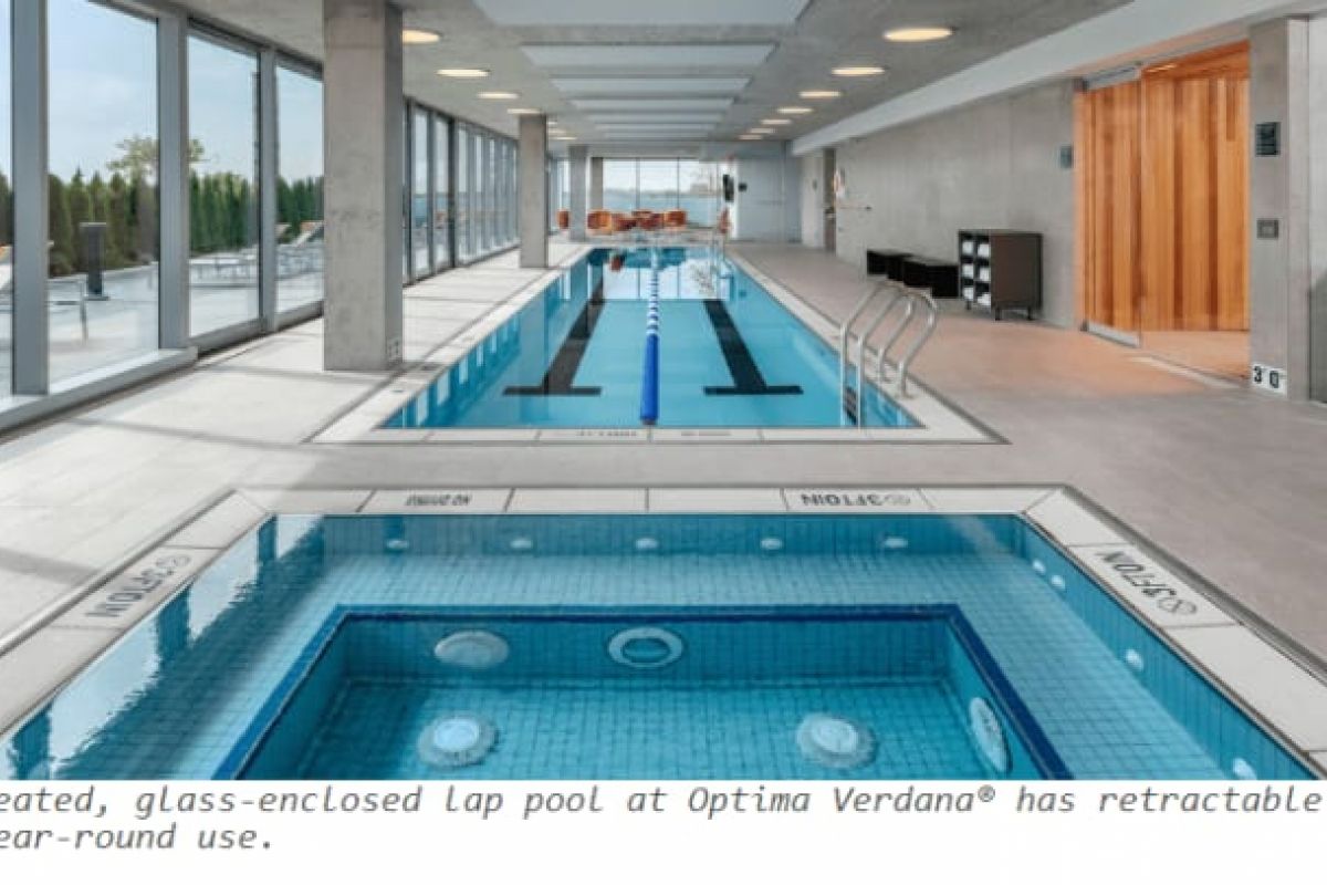 Optima Verdana luxury apartment with Enjoy Winter Wellness at Optima with an indoor heated lap pool, glass walls, loungers, and a hot tub in a modern, light-filled space.