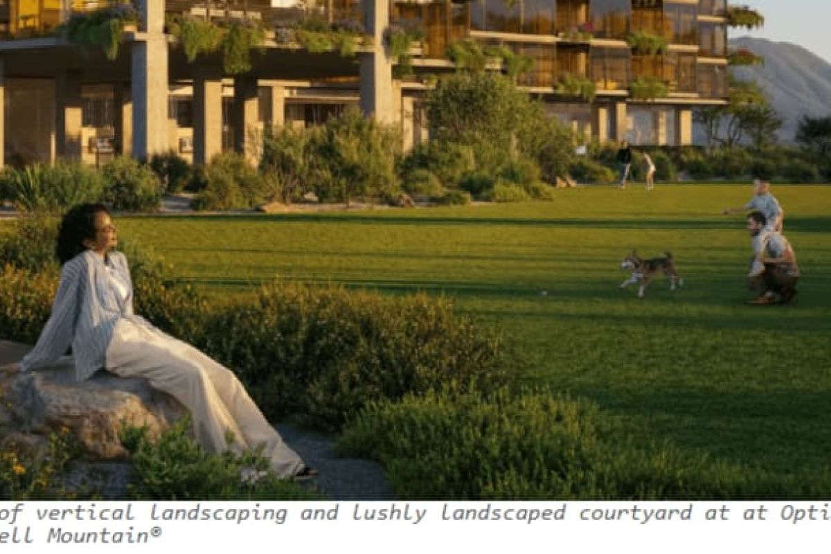 Optima Verdana luxury apartment with A woman relaxes on a rock while people and dogs play on a green lawn near the Regenerative Architecture of Optima Verdana apartments.