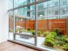 Optima Verdana luxury apartment with Modern room with wood floors, large windows, and views of a pet-friendly patio garden at Optima Verdana.